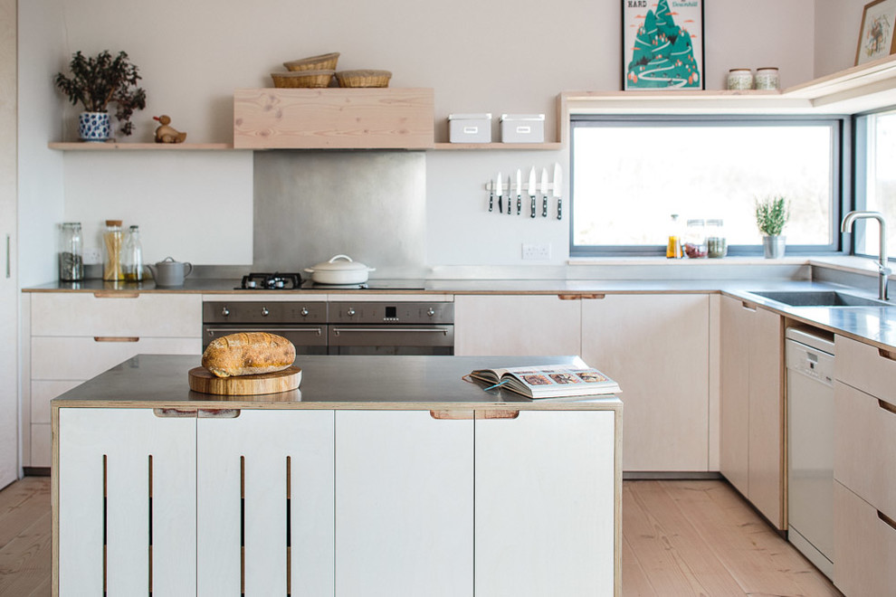Photo of a mid-sized scandinavian l-shaped eat-in kitchen in Other with a farmhouse sink, flat-panel cabinets, light wood cabinets, stainless steel benchtops, metallic splashback, stainless steel appliances, light hardwood floors and with island.