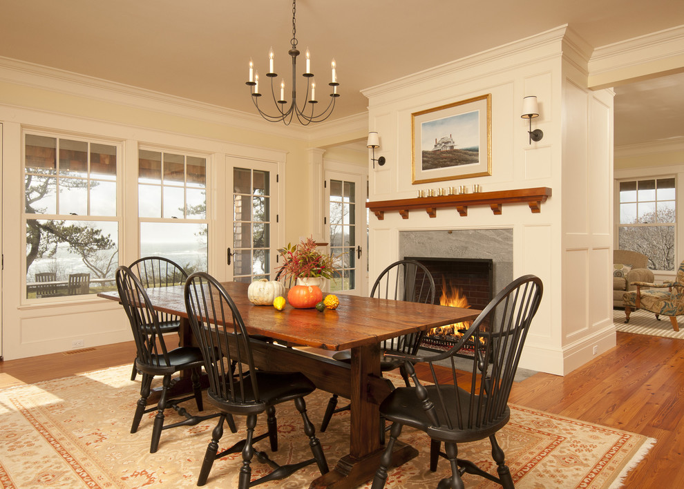 Design ideas for a traditional dining room in Boston with beige walls, medium hardwood floors and a standard fireplace.