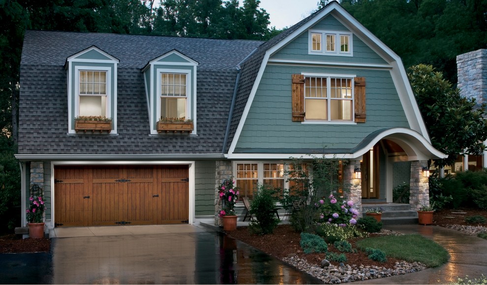 This is an example of a mid-sized country three-storey green exterior in Nashville with mixed siding and a gable roof.