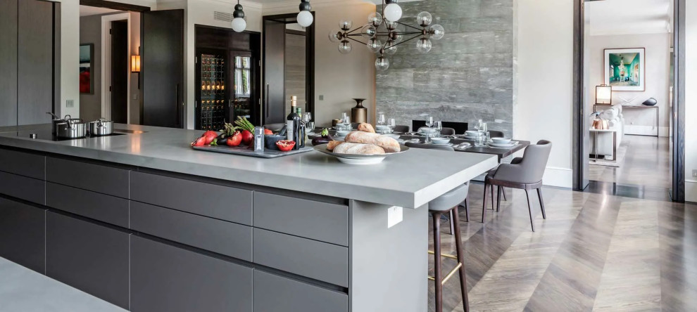 This is an example of a large contemporary galley eat-in kitchen in Moscow with flat-panel cabinets, grey cabinets, quartzite benchtops, grey splashback, with island and grey benchtop.