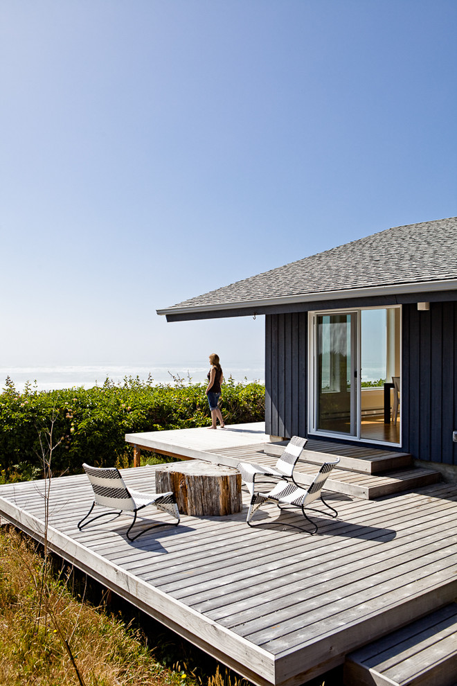 This is an example of a beach style deck in Portland with no cover.