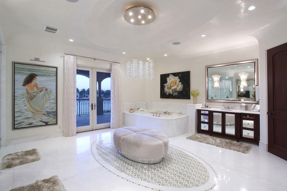 Design ideas for a mediterranean master bathroom in Miami with an undermount sink, flat-panel cabinets, a drop-in tub, white tile and white walls.