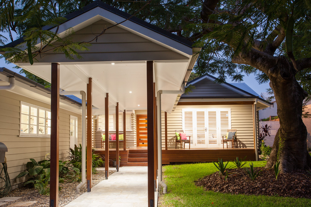 Photo of a small transitional front yard verandah in Brisbane with decking and a roof extension.