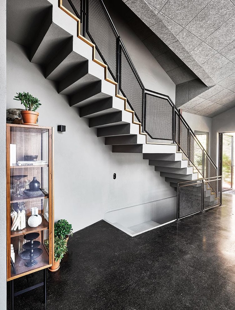 Mid-sized industrial painted wood straight staircase in Cologne with painted wood risers and metal railing.
