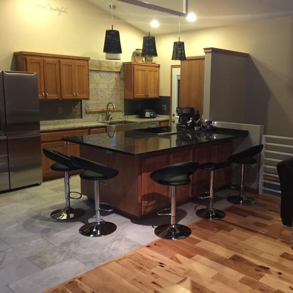 Open concept kitchen - mid-sized transitional single-wall medium tone wood floor and brown floor open concept kitchen idea with a farmhouse sink, recessed-panel cabinets, medium tone wood cabinets, quartz countertops and an island