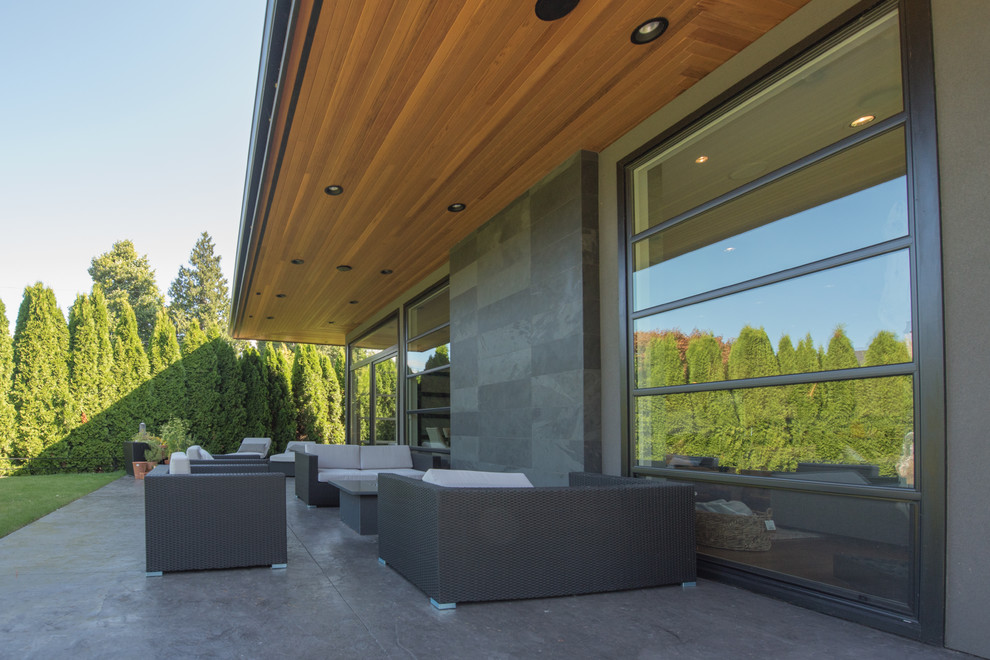 Large contemporary two-storey stucco grey exterior in Vancouver with a flat roof.