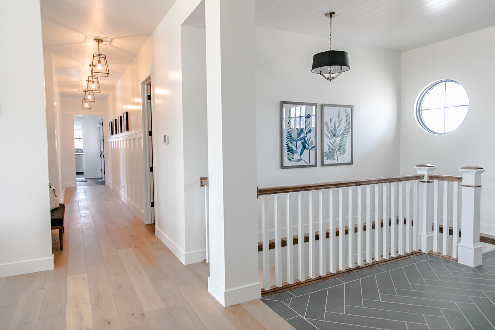 Design ideas for a mid-sized country foyer in Salt Lake City with white walls, porcelain floors, a single front door, a black front door and black floor.