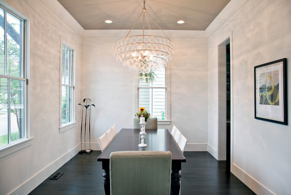 Contemporary dining room in Charleston with white walls.