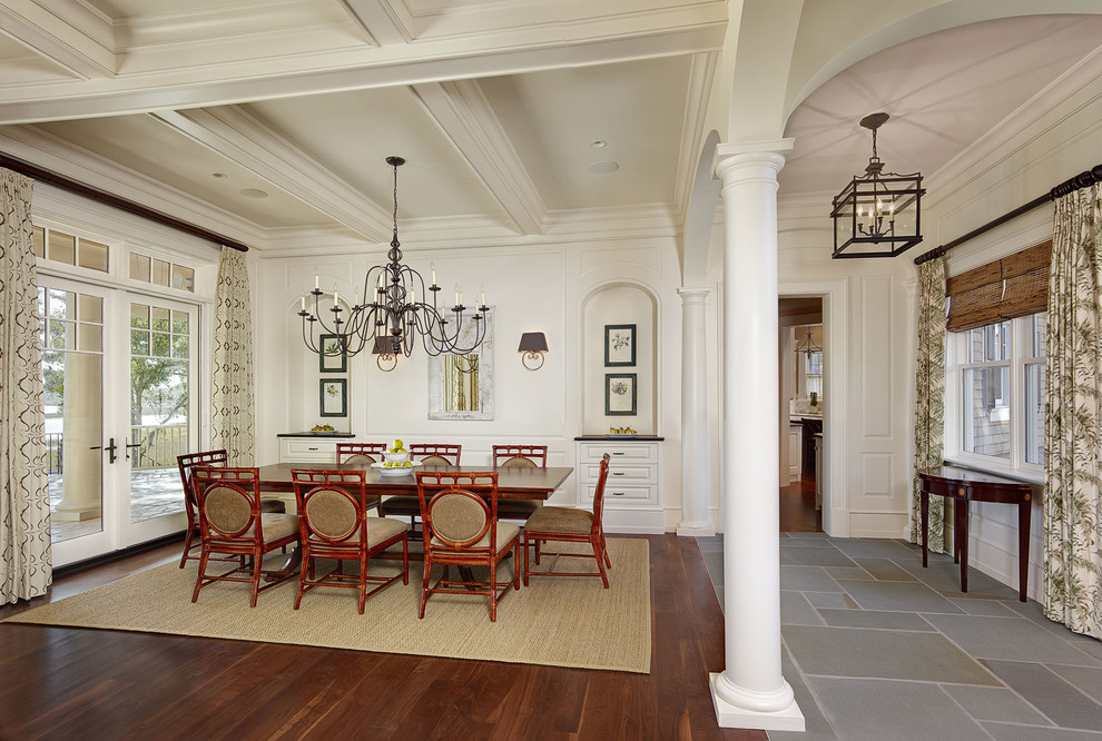 Design ideas for a traditional dining room in Charleston with white walls and dark hardwood floors.
