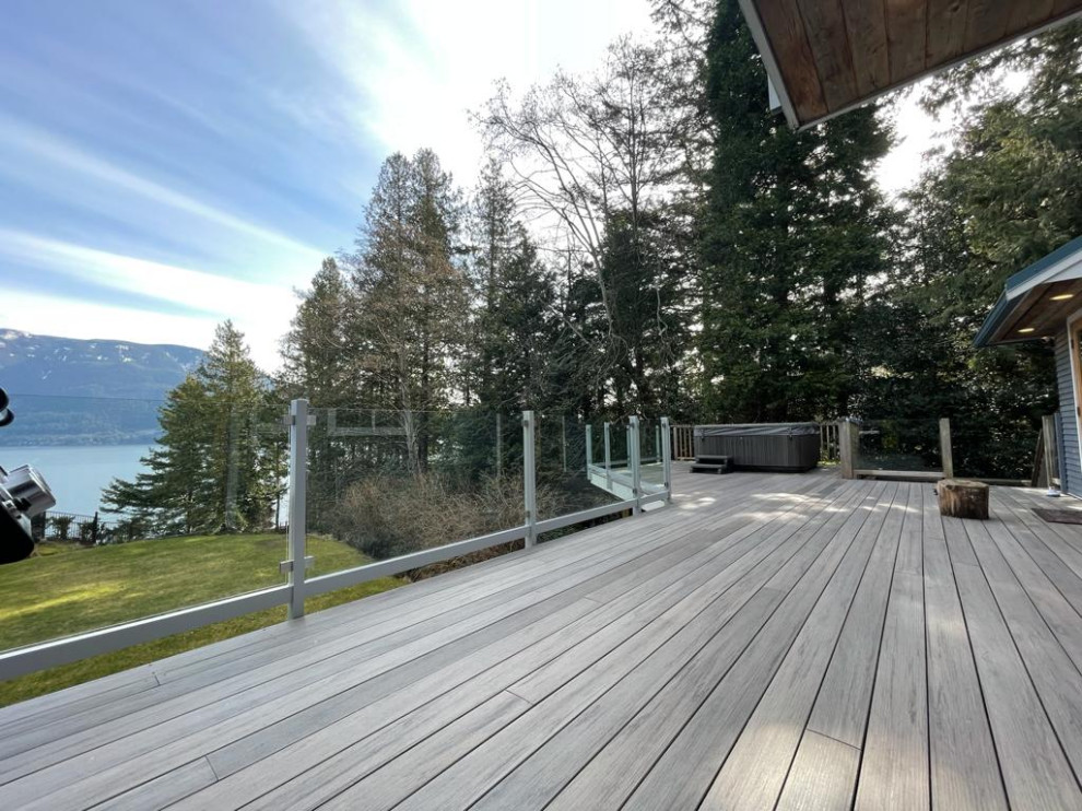 Mid-sized trendy courtyard glass railing deck photo in Vancouver with no cover