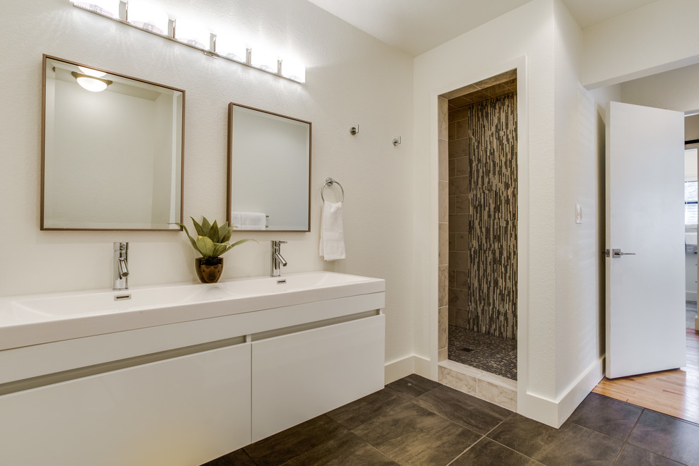 Photo of a mid-sized country master bathroom in Dallas with flat-panel cabinets, white cabinets, a corner shower, multi-coloured tile, matchstick tile, grey walls, porcelain floors, an integrated sink, engineered quartz benchtops, brown floor, an open shower and white benchtops.