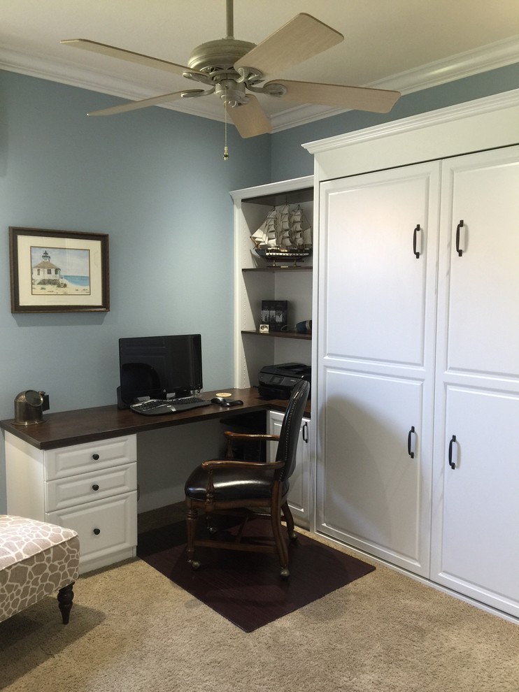 This is an example of a mid-sized traditional home office in Tampa with a built-in desk.