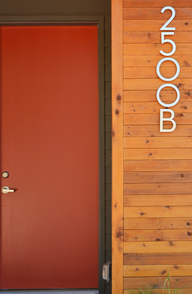 Home design - modern home design idea in Austin with a red front door