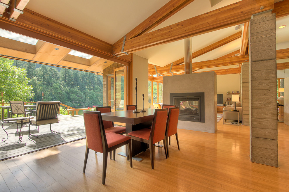 Design ideas for a contemporary dining room in Portland with beige walls and medium hardwood floors.