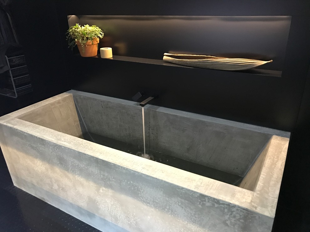 Design ideas for a large industrial master bathroom in Sydney with a japanese tub, white walls, linoleum floors and black floor.