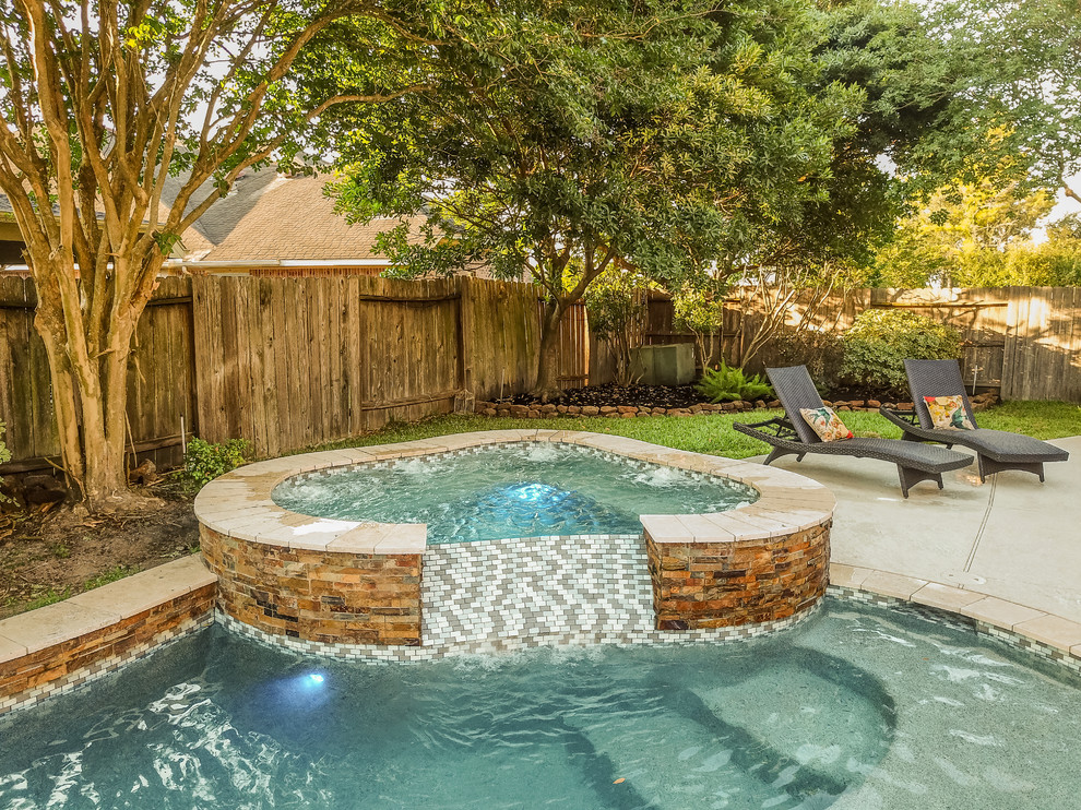 Photo of a mid-sized contemporary backyard custom-shaped pool in Houston with a water feature and tile.