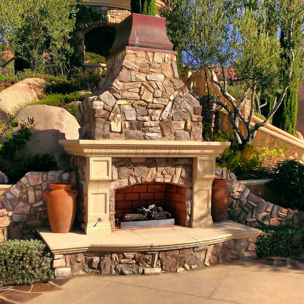 Large mediterranean backyard patio in San Diego with a fire feature, concrete slab and no cover.
