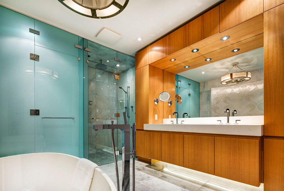 Photo of a contemporary bathroom in Montreal with an integrated sink, a freestanding tub and a curbless shower.