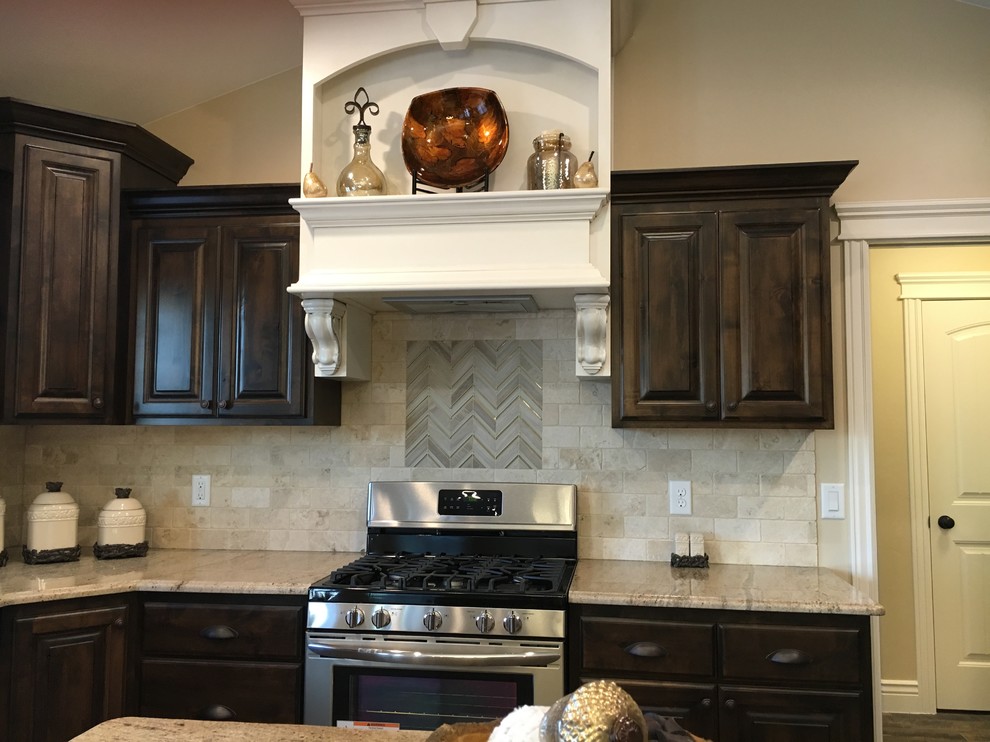 Large transitional u-shaped porcelain tile open concept kitchen photo with an undermount sink, raised-panel cabinets, dark wood cabinets, granite countertops, beige backsplash, stone tile backsplash, stainless steel appliances and an island