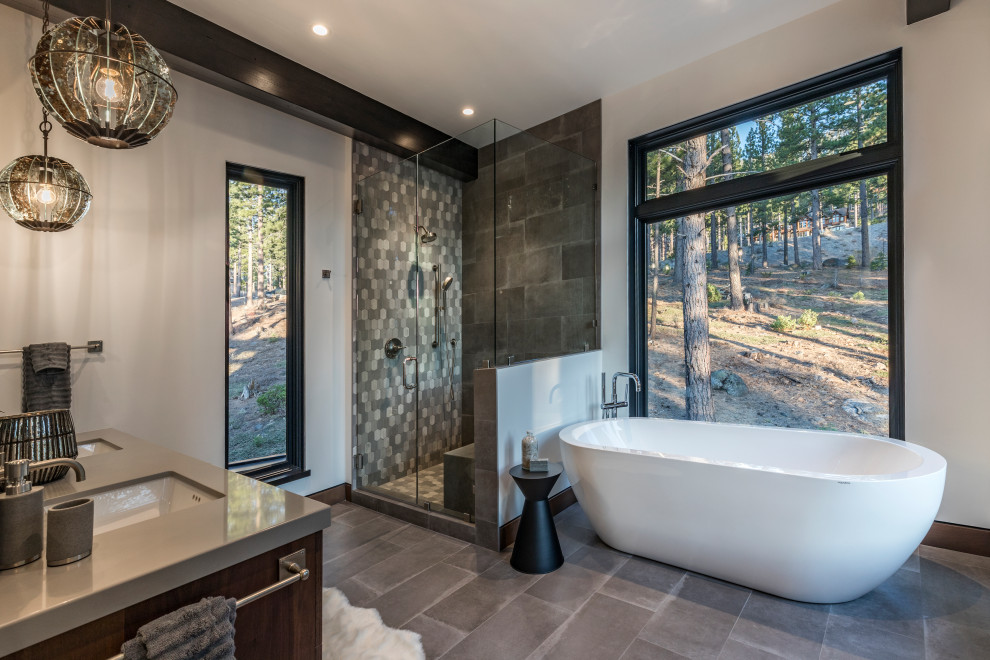 This is an example of a country bathroom in Other with dark wood cabinets, a freestanding tub, a corner shower, white walls, an undermount sink, grey floor, a hinged shower door, grey benchtops, a shower seat and a double vanity.