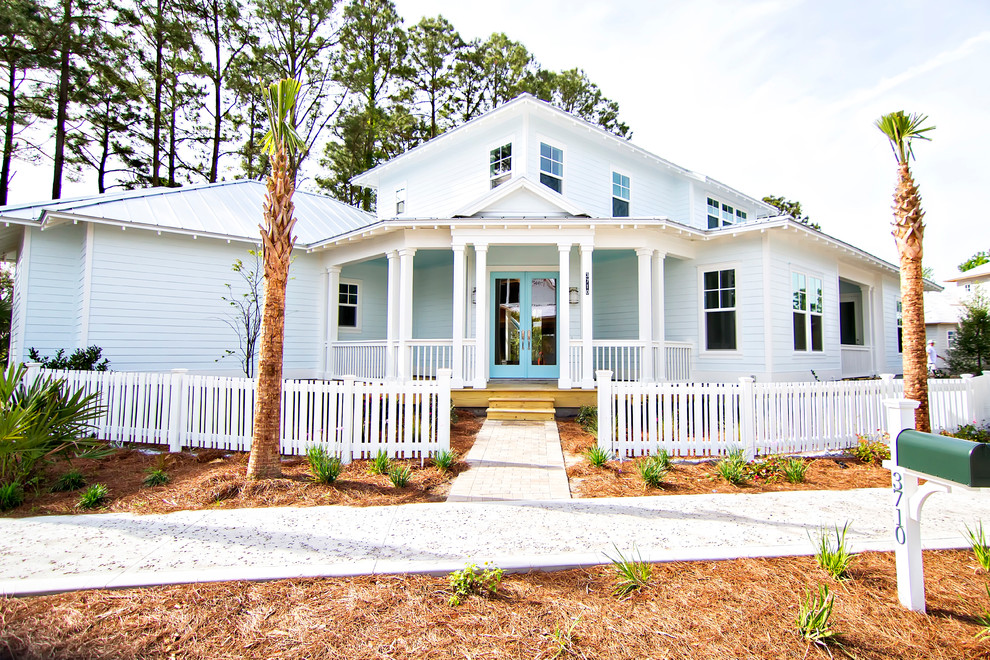 Photo of a mid-sized beach style two-storey blue exterior in Jacksonville with concrete fiberboard siding and a clipped gable roof.