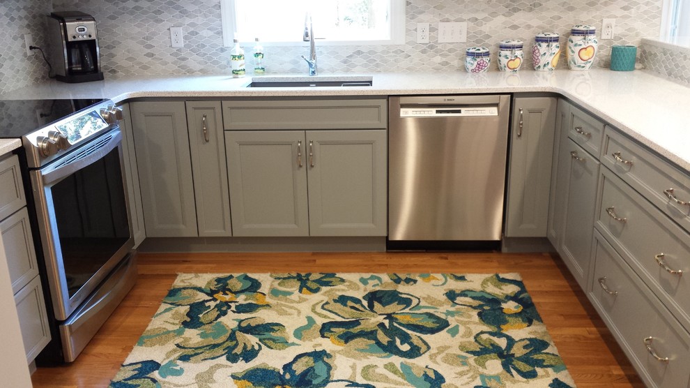 Example of a transitional u-shaped medium tone wood floor kitchen design in Boston with an undermount sink, gray cabinets, quartz countertops, multicolored backsplash and a peninsula