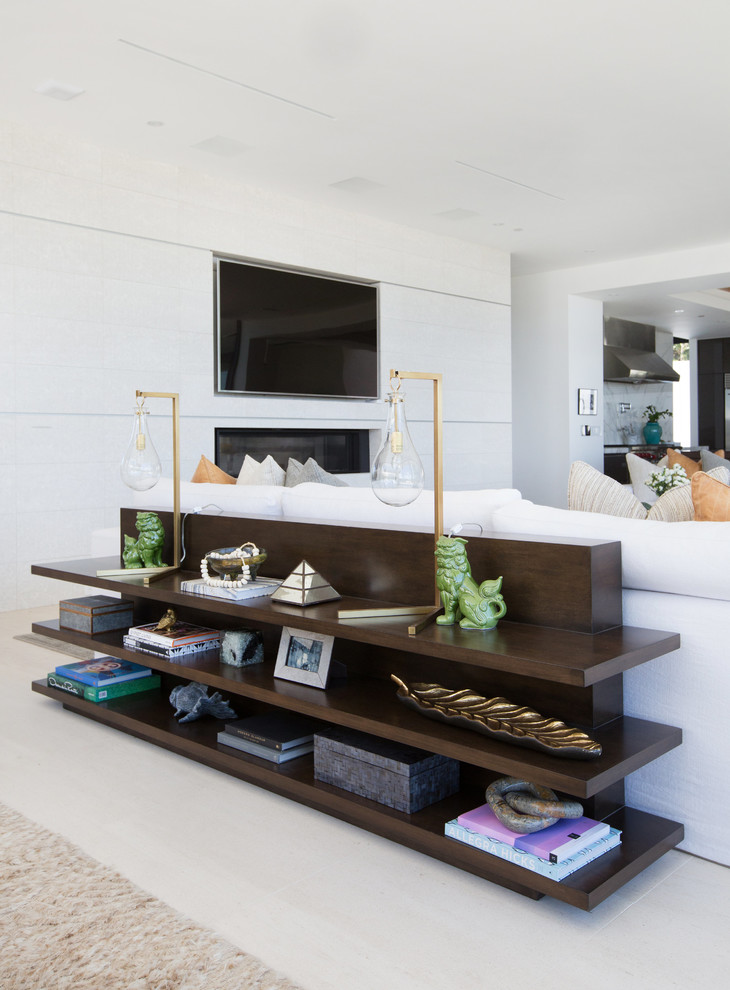 Photo of an expansive contemporary formal open concept living room in Los Angeles with white walls, limestone floors, a two-sided fireplace, a tile fireplace surround and a wall-mounted tv.
