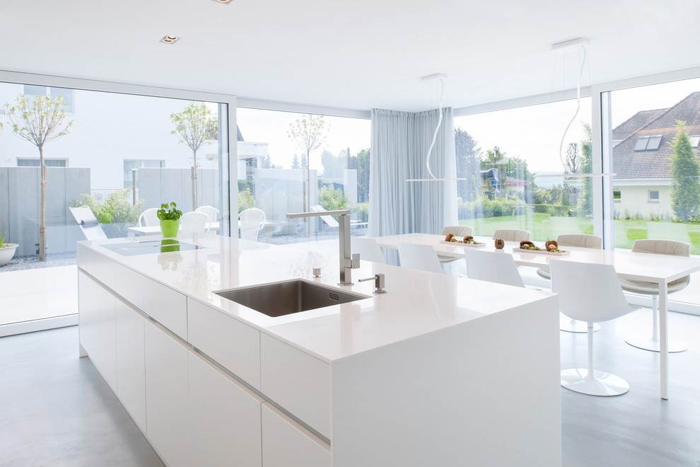 Contemporary galley kitchen in Milan with an undermount sink, flat-panel cabinets, white cabinets and with island.