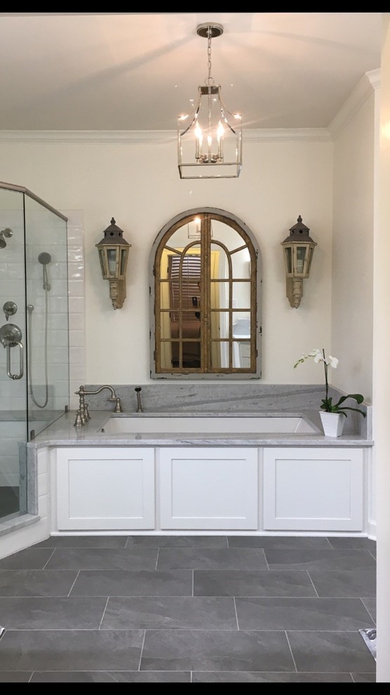 Example of a mid-sized transitional master white tile and ceramic tile porcelain tile and gray floor corner shower design with recessed-panel cabinets, white cabinets, an undermount tub, a two-piece toilet, gray walls, an undermount sink, marble countertops and a hinged shower door