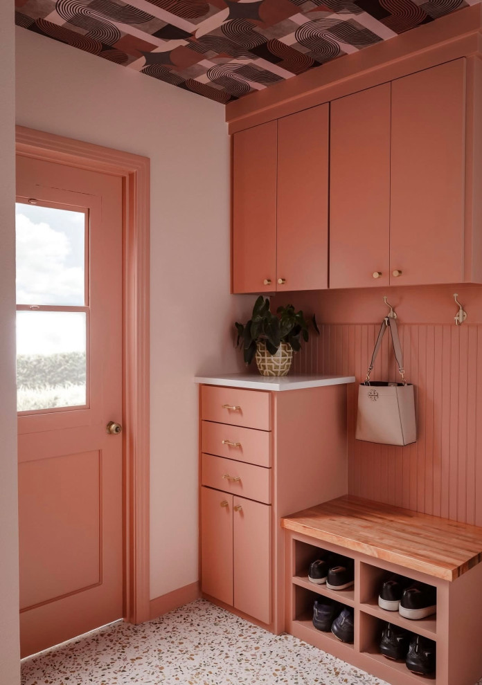 Trendy terrazzo floor and multicolored floor mudroom photo in Dallas with orange walls and an orange front door