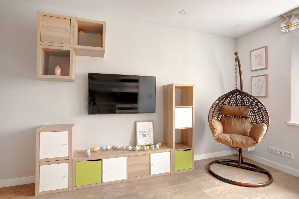 Inspiration for a mid-sized contemporary gender-neutral kids' playroom for kids 4-10 years old in Saint Petersburg with white walls, light hardwood floors, beige floor and wallpaper.
