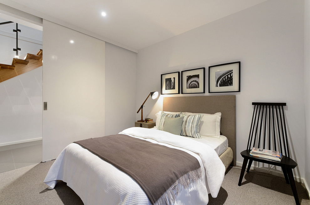 This is an example of a mid-sized contemporary bedroom in Melbourne with carpet.