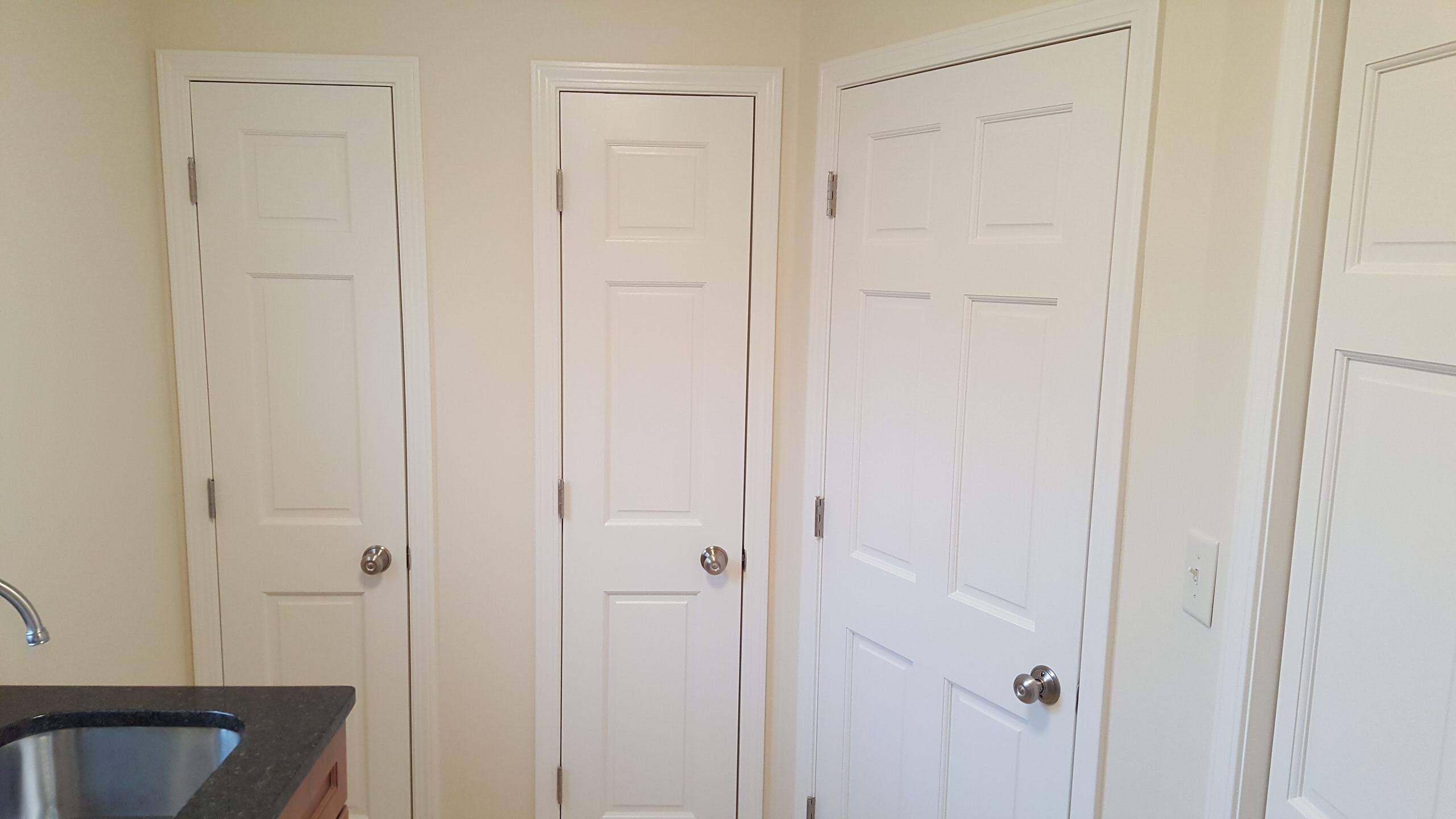 Laundry room...left door=broom closet, center=linen closet rear door, right=hall