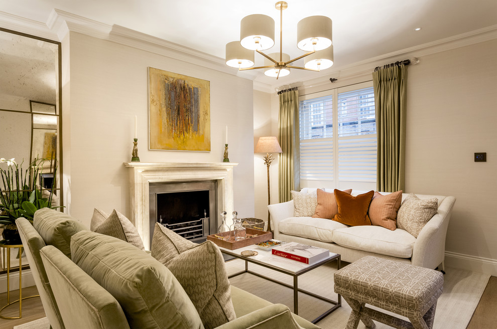 This is an example of a mid-sized traditional open concept living room in London with grey walls, medium hardwood floors, a stone fireplace surround, a standard fireplace and brown floor.