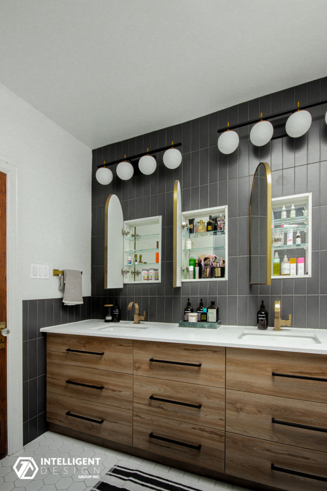 Photo of a large scandinavian ensuite bathroom in Toronto with flat-panel cabinets, medium wood cabinets, a corner shower, a one-piece toilet, grey tiles, porcelain tiles, white walls, mosaic tile flooring, a submerged sink, engineered stone worktops, white floors, a hinged door, white worktops, double sinks and a built in vanity unit.