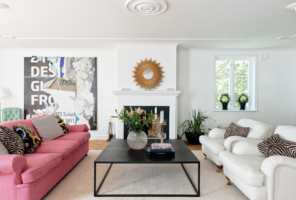 Photo of a large traditional formal open concept living room in Stockholm with white walls, a standard fireplace, light hardwood floors and no tv.