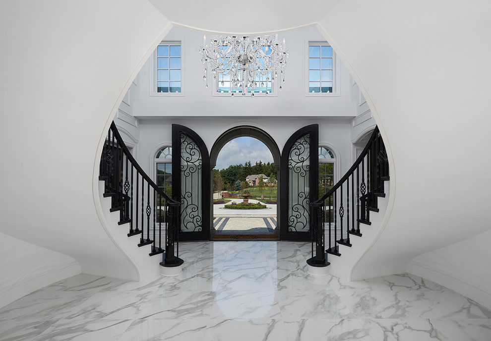 Photo of an expansive transitional foyer in Detroit with white walls, marble floors, a double front door and a black front door.