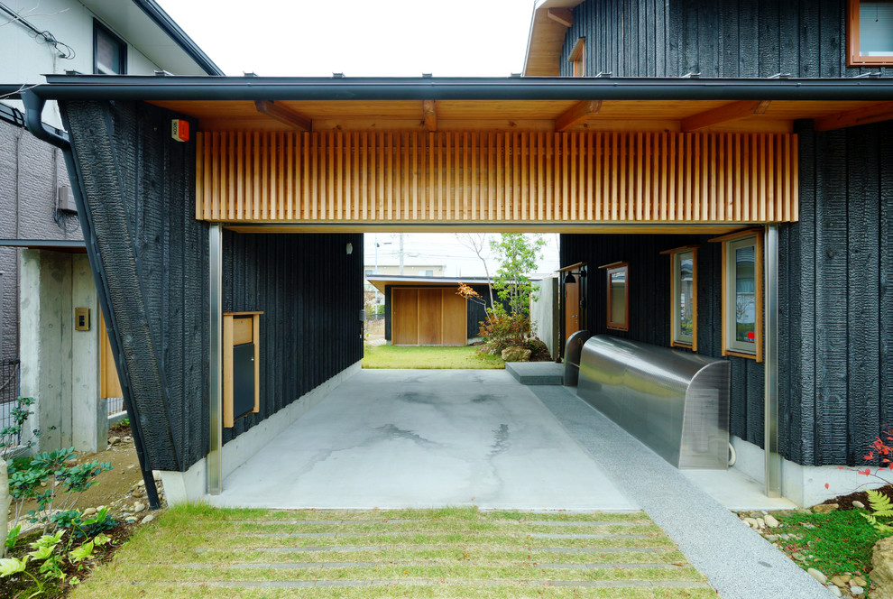 This is an example of a contemporary attached one-car carport in Other.