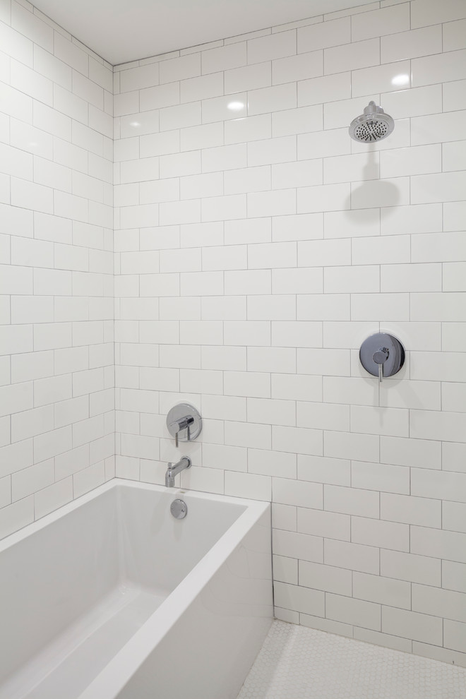 На фото: главная, серо-белая ванная комната в стиле модернизм с плоскими фасадами, темными деревянными фасадами, унитазом-моноблоком, белой плиткой, белыми стенами, настольной раковиной, мраморной столешницей, серой столешницей, тумбой под одну раковину, подвесной тумбой, многоуровневым потолком, отдельно стоящей ванной, душем над ванной, плиткой кабанчик, полом из мозаичной плитки, белым полом и открытым душем с