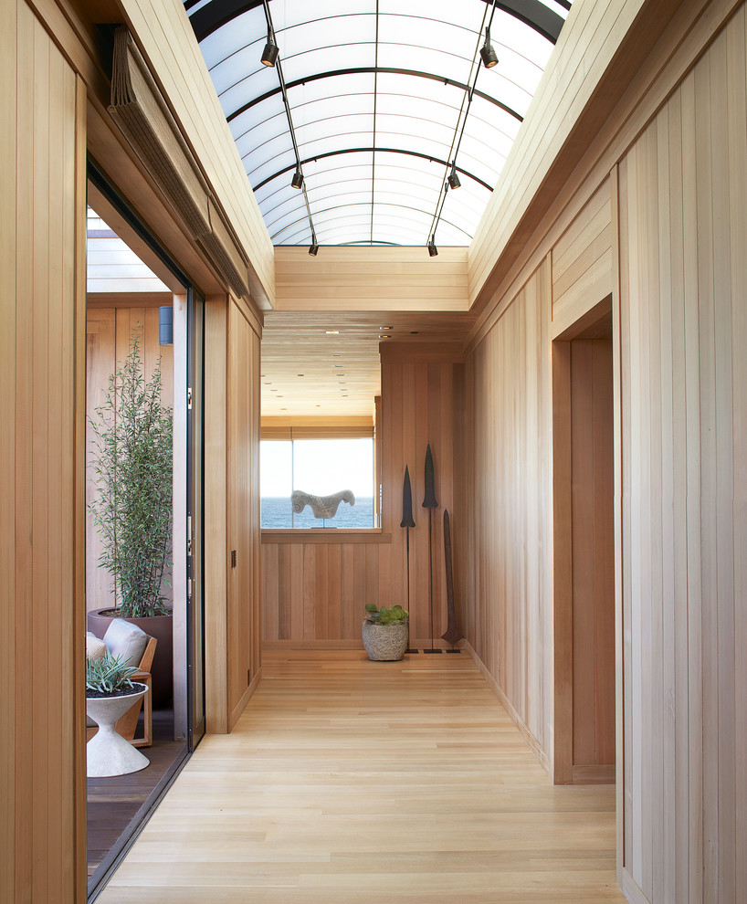 This is an example of a mid-sized contemporary hallway in San Francisco with beige walls and light hardwood floors.
