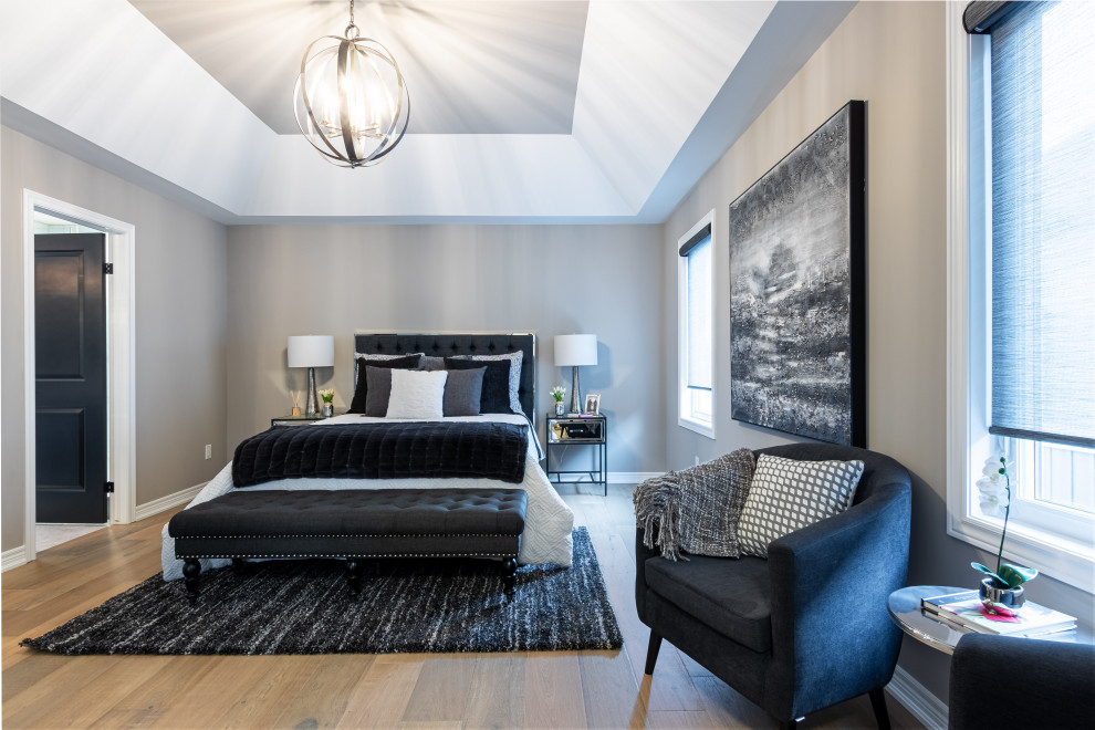 Inspiration for a transitional master bedroom in Toronto with grey walls, light hardwood floors and white floor.