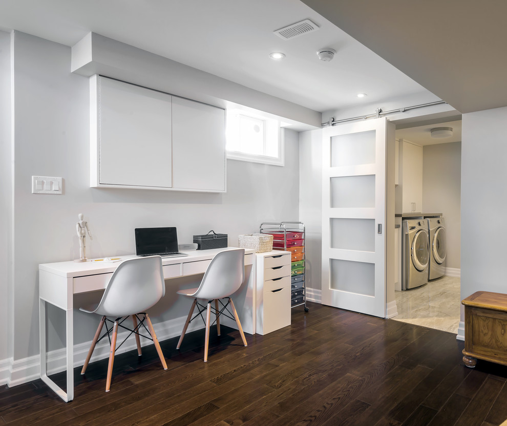 Inspiration for a small transitional look-out dark wood floor basement remodel in Toronto with gray walls