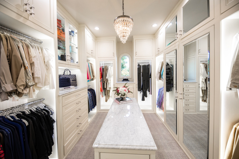 Photo of a large traditional women's walk-in wardrobe in Dallas with beaded inset cabinets, white cabinets, carpet and beige floor.
