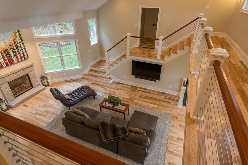 Photo of an expansive transitional wood curved staircase in Boston with wood risers.