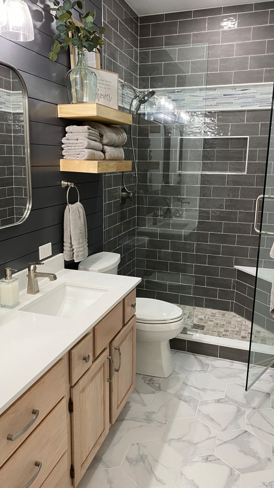 Photo of a small country 3/4 bathroom in Dallas with raised-panel cabinets, light wood cabinets, an alcove shower, gray tile, subway tile, grey walls, porcelain floors, an undermount sink, engineered quartz benchtops, grey floor, a hinged shower door, white benchtops, a shower seat, a double vanity, a built-in vanity and planked wall panelling.
