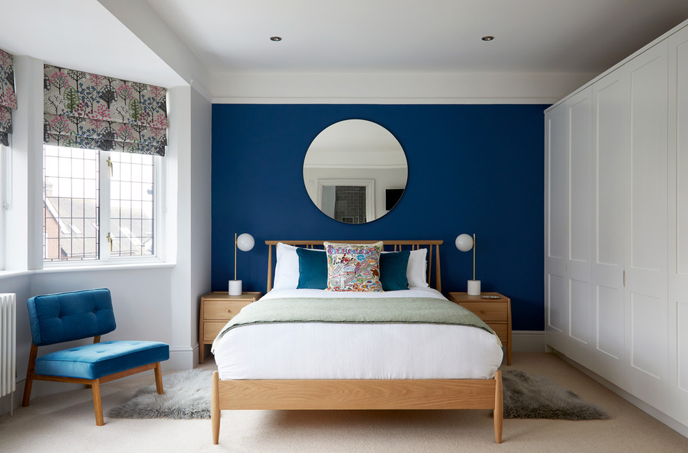 Photo of a transitional master bedroom in Surrey with blue walls, carpet, no fireplace and beige floor.