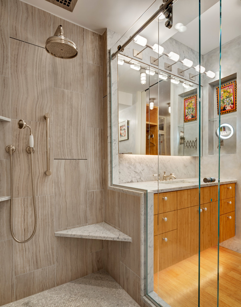 This is an example of a small contemporary bathroom in New York with flat-panel cabinets, light wood cabinets, an alcove shower, gray tile, stone slab, grey walls, bamboo floors, an undermount sink and marble benchtops.