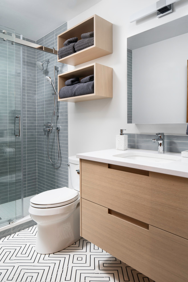 Inspiration for a small modern 3/4 bathroom in Denver with flat-panel cabinets, light wood cabinets, an alcove shower, a two-piece toilet, gray tile, ceramic tile, white walls, cement tiles, an undermount sink, engineered quartz benchtops, a sliding shower screen, white benchtops, a single vanity and a floating vanity.