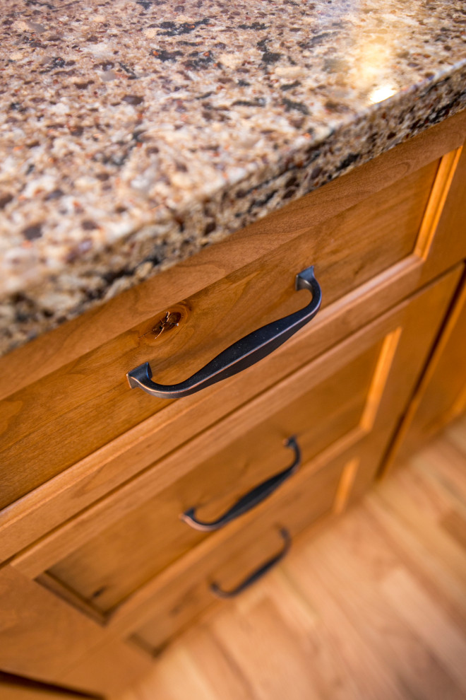 Inspiration for a mid-sized rustic galley medium tone wood floor and brown floor eat-in kitchen remodel in Denver with an undermount sink, shaker cabinets, medium tone wood cabinets, quartz countertops, gray backsplash, stone tile backsplash, black appliances, no island and brown countertops