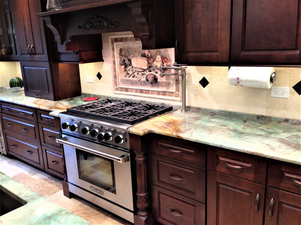 Inspiration for a mid-sized transitional travertine floor and beige floor eat-in kitchen remodel in Chicago with a double-bowl sink, raised-panel cabinets, dark wood cabinets, quartzite countertops, beige backsplash, stone tile backsplash, stainless steel appliances and an island